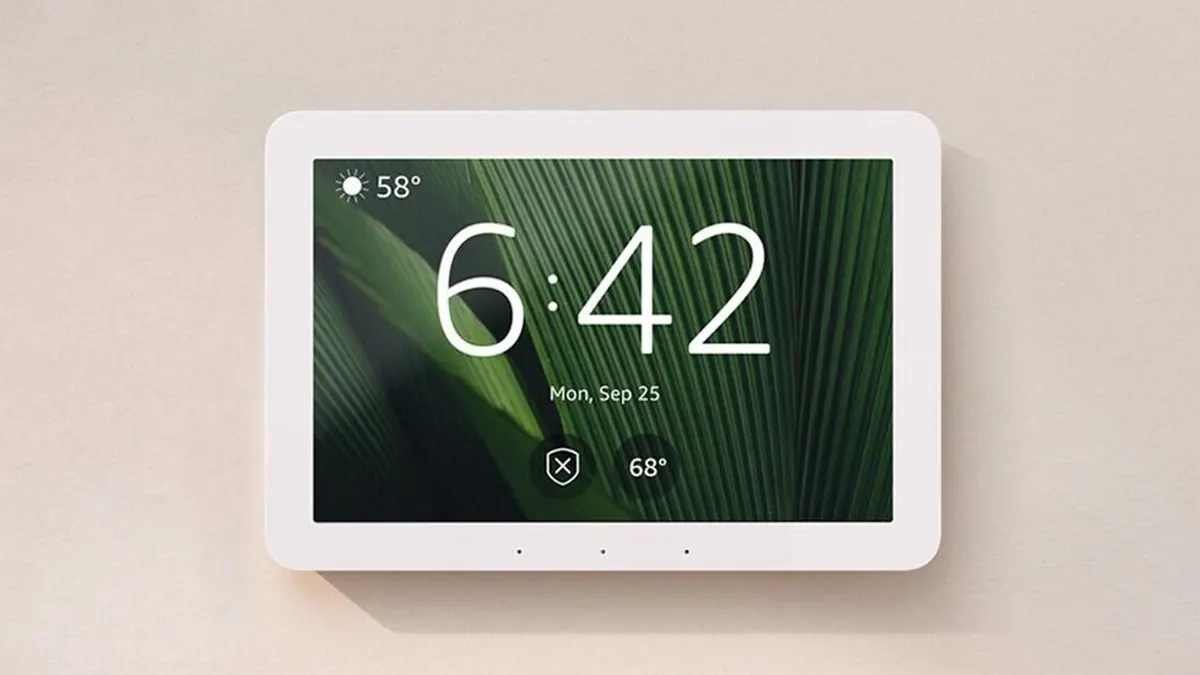 Amazon Echo Hub mounted on a wall showing the clock home screen